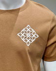 Brown t-shirt with a white geometric pattern on a mannequin against a gray background